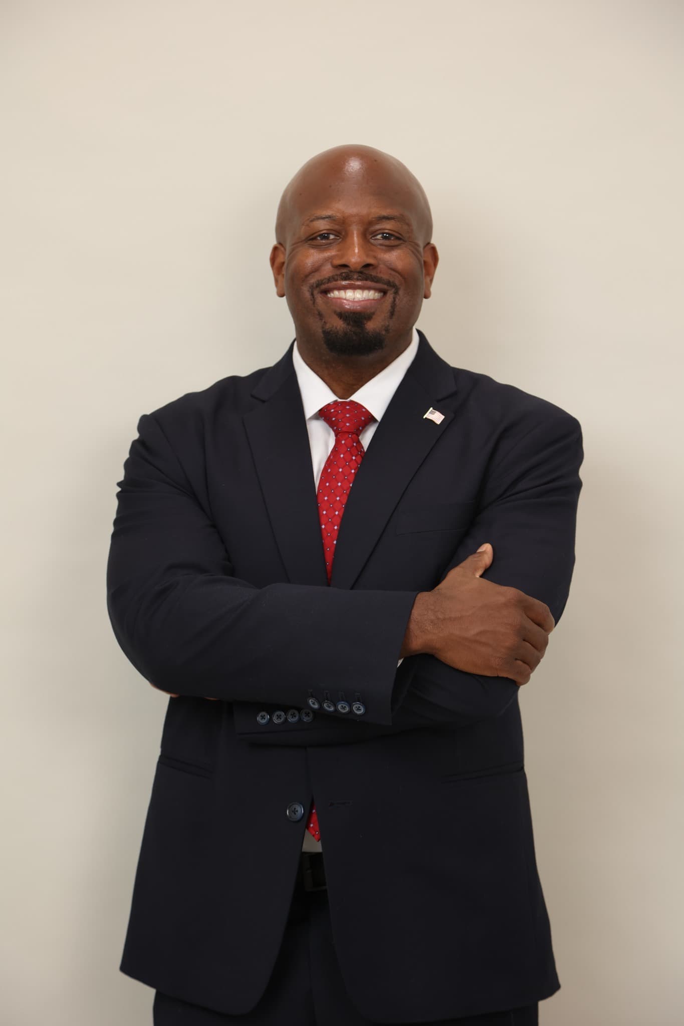 Brandon K. Taylor in a navy suit and red tie